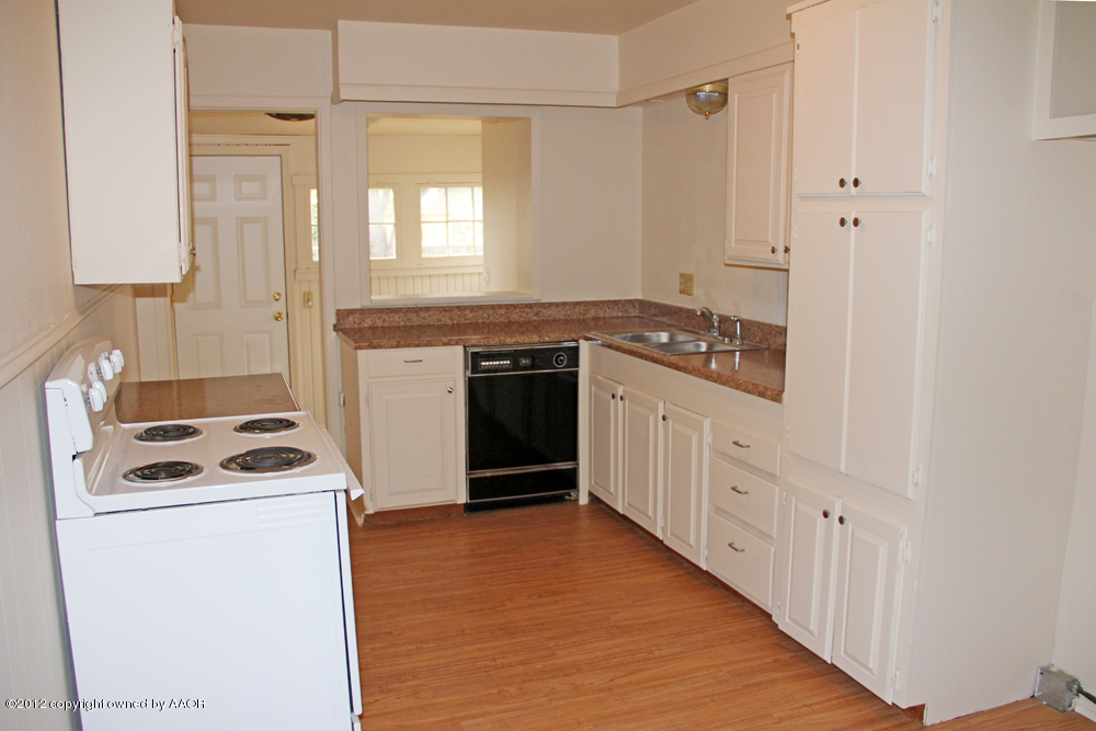 3604 South Hayden Street Amarillo, TX 79110 - Photo 8 of 21 a kitchen with a stove sink and cabinets