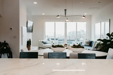 a large living room with large windows and furniture