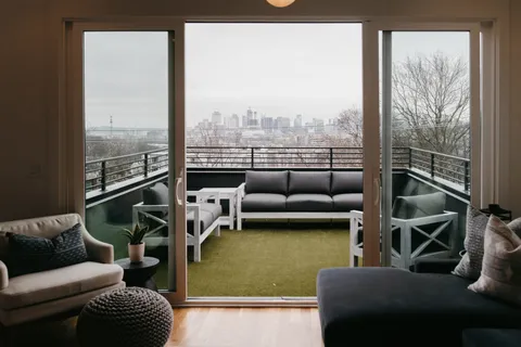 a balcony with furniture and a floor to ceiling window