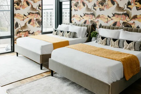 a bedroom with two beds and a window