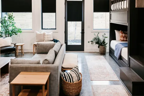 a bedroom with a bed wooden floor and window