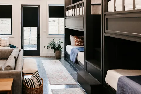 a bedroom with a bed a window and wall