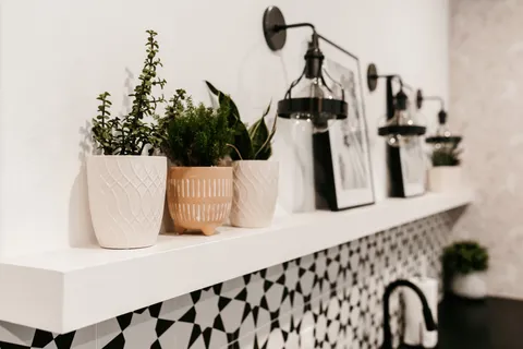 a bedroom with a bed and a potted plant