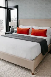 a bedroom with bed and a night stand