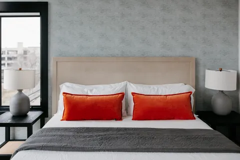 a bathroom with a granite countertop double vanity sink and mirror