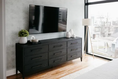 a bedroom with a bed and a mirror