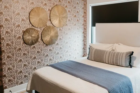 a bedroom with a bed and a mirror