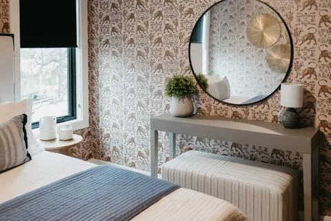 a bedroom with a bed and a lamp