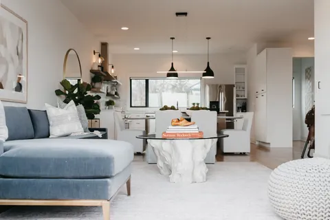 a living room with furniture and kitchen view
