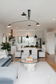 a living room with furniture and a chandelier