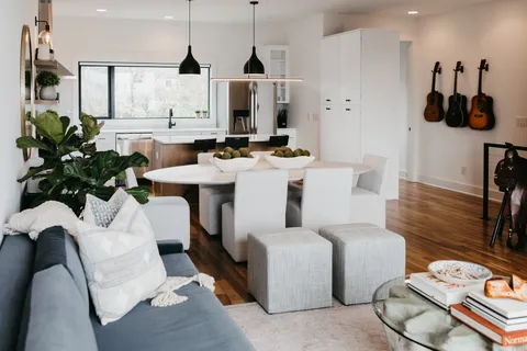 a living room with furniture and a chandelier