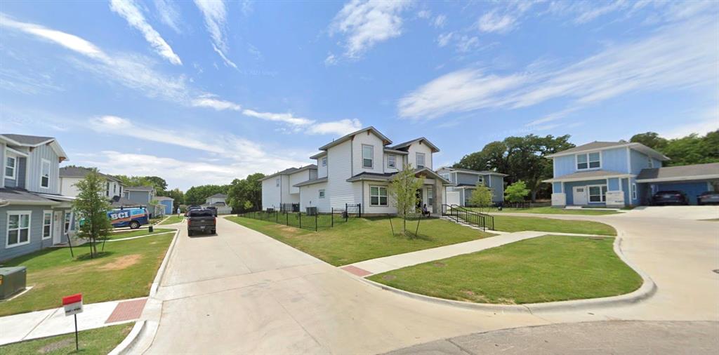 1904 Sena Street, Unit 101 Denton, TX 76201 - Photo 1 of 2 Two-story residence featuring a light-colored exterior, an inviting front porch, and a well-maintained green lawn