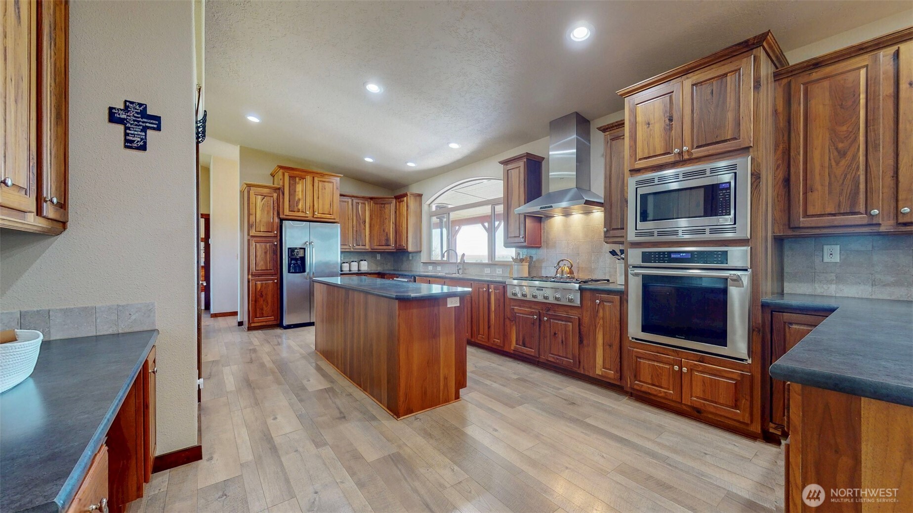 1461 Sheffield Road Mesa, WA 99343 - Photo 11 of 40 a kitchen with stainless steel appliances granite countertop a stove a sink dishwasher a microwave oven and a refrigerator with wooden cabinets