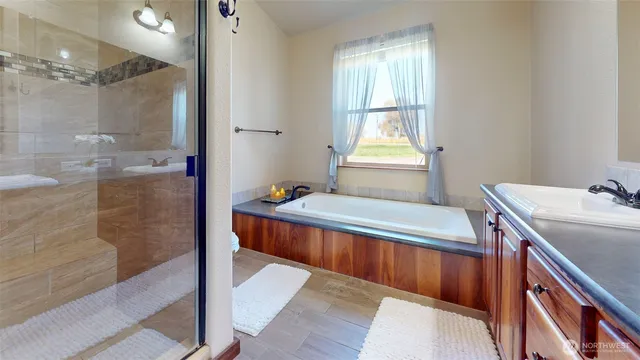 a bathroom with a tub sink and shower