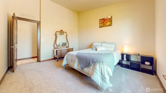 a bedroom with a bed and dresser