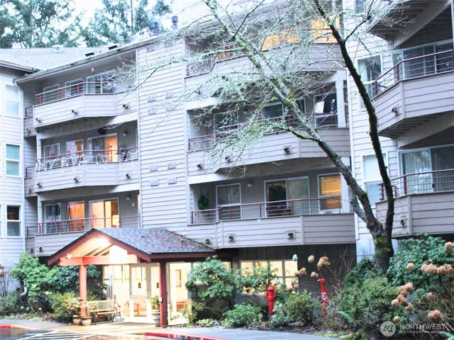 a front view of a house with a yard and potted plants