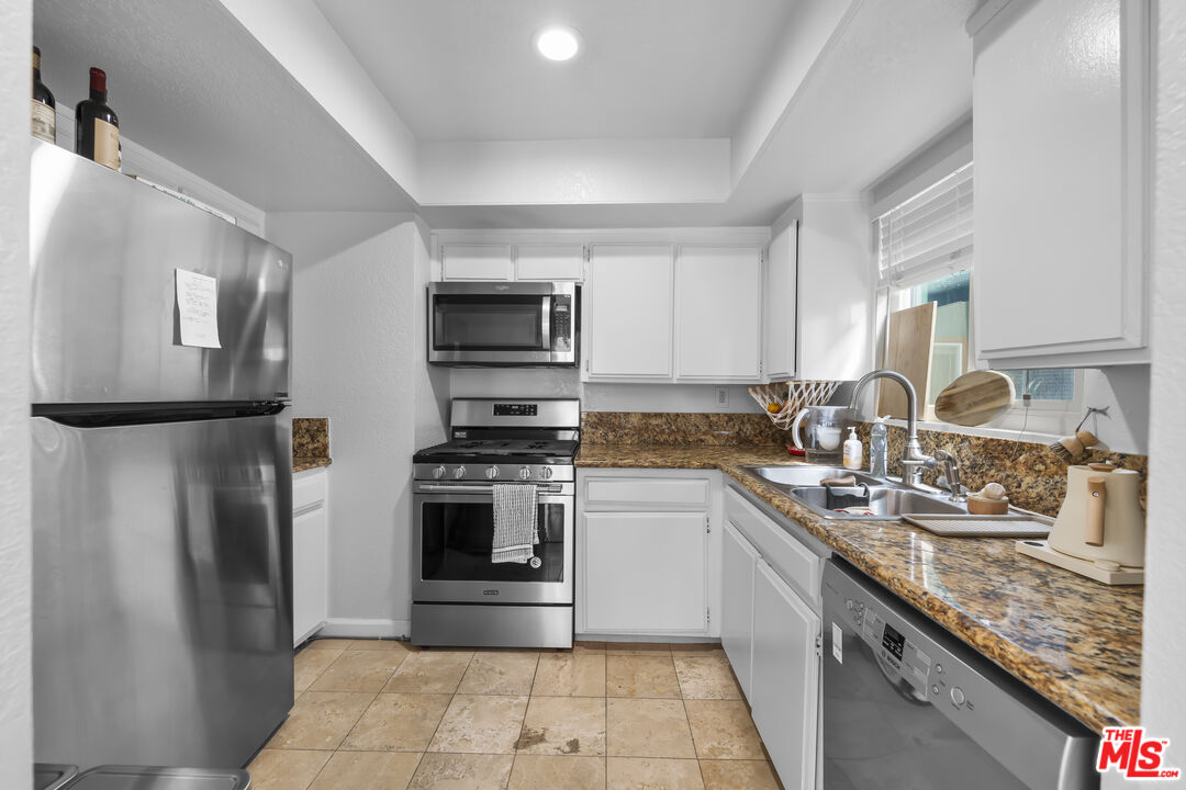 23 Buccaneer Street Marina del Rey, CA 90292 - Photo 11 of 39 a kitchen with a sink a refrigerator and a stove top oven