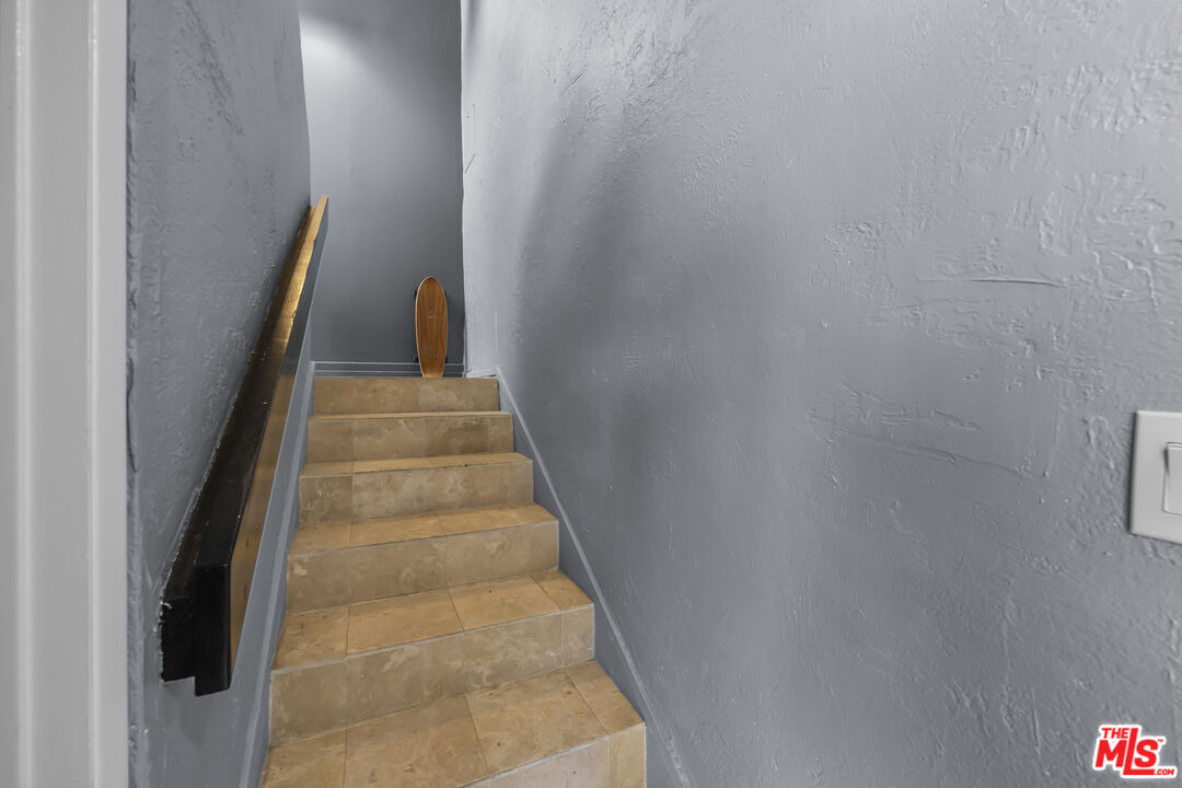23 Buccaneer Street Marina del Rey, CA 90292 - Photo 22 of 39 a view of staircase with wooden floor and white walls