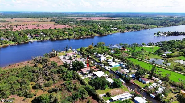 an aerial view of a houses with a lake view