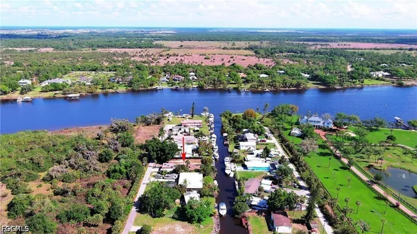 an aerial view of a houses with a lake