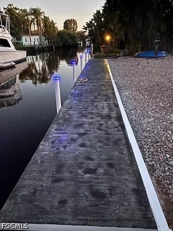 a swimming pool with outdoor seating and lake view