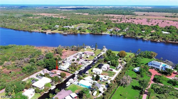 an aerial view of a houses with a lake
