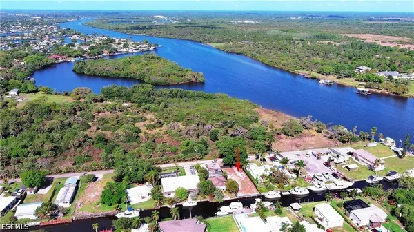 an aerial view of a house with a garden and lake view