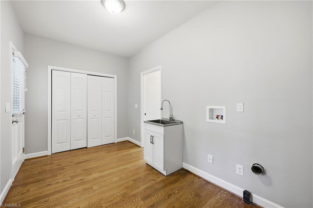 8861 Boylston Road Colfax, NC 27235 - Photo 23 of 50 Spacious main-level laundry room with utility sink, generous storage potential, and direct access to the screened porch—ready to customize to your needs.