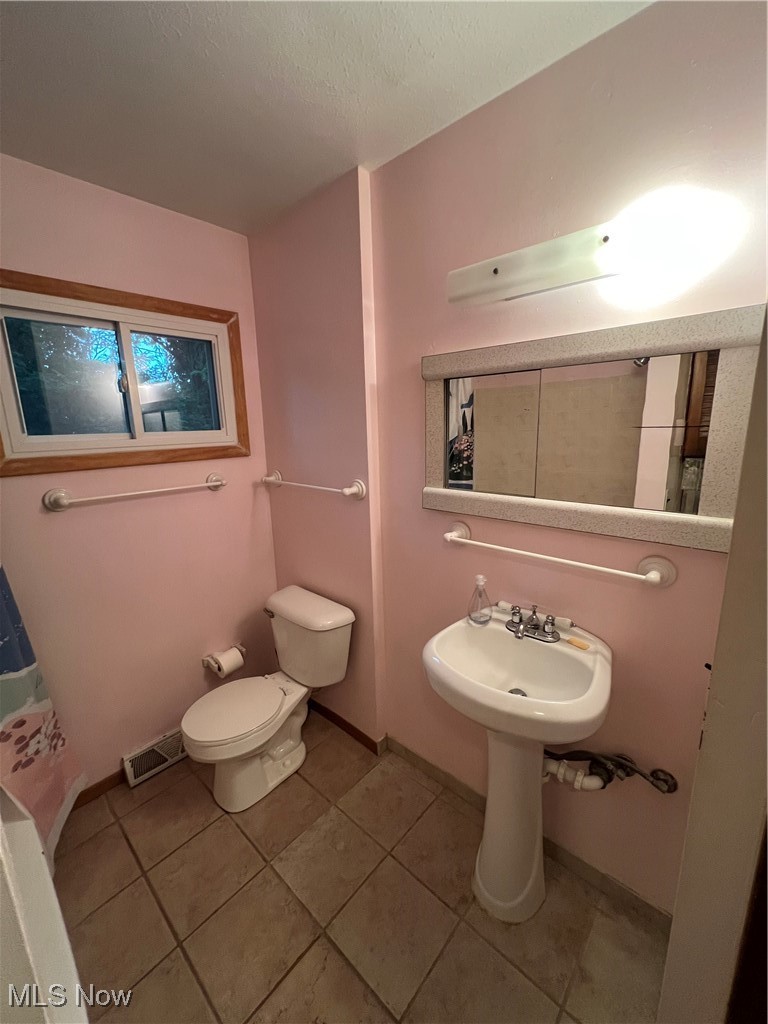 218 Nobottom Road Berea, OH 44017 - Photo 10 of 14 Bathroom featuring light tile patterned floors and a textured ceiling