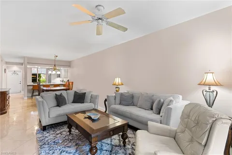 a living room with furniture a rug and a chandelier