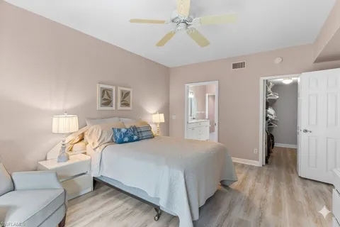 a bedroom with a bed couch and a walk in closet
