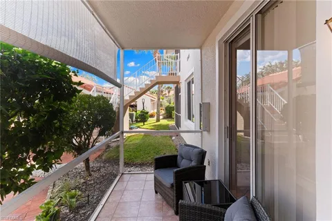 a view of a porch with furniture and garden