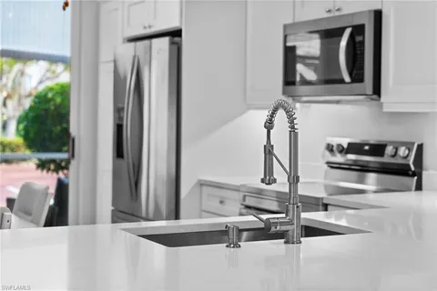 a kitchen with a refrigerator and a sink