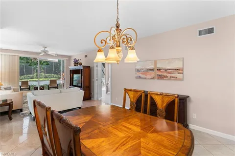 a very nice looking dining room with a large dining table and chairs