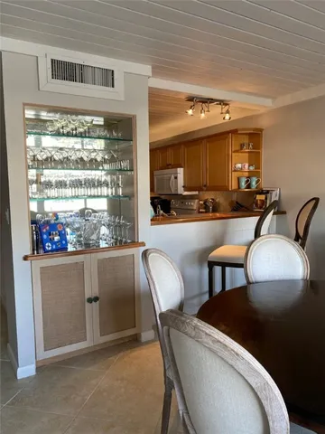 a dining room with furniture a chandelier and window