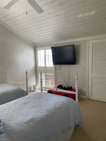 a bed room with a bed and a television