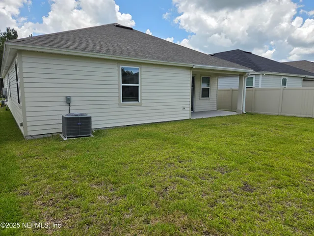 a backyard of a brick house with a small yard and a large window