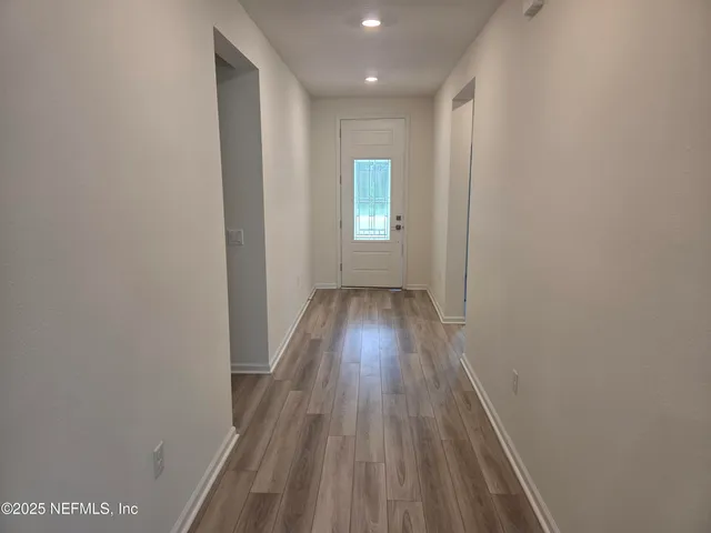 a view of hallway with wooden floor