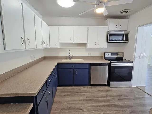 a bathroom with a sink and cabinets