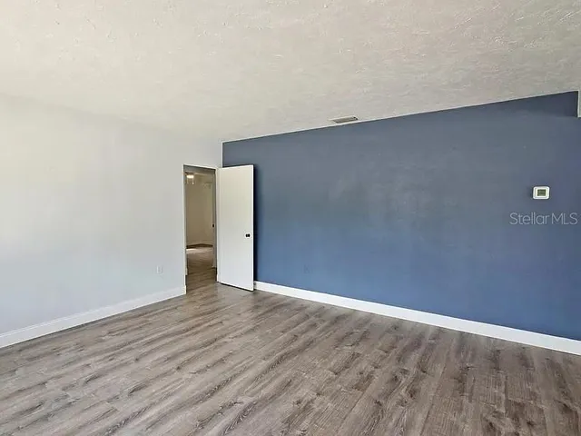 a view of a backyard with large trees and a small yard