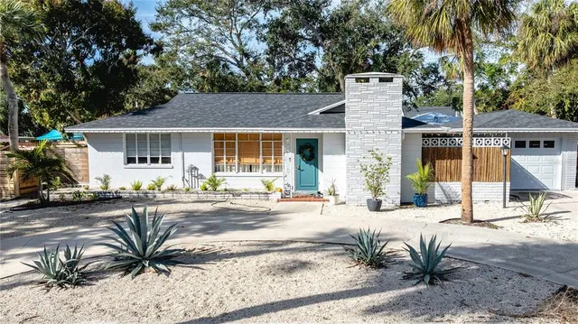 an aerial view of residential house with outdoor space and trees around
