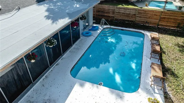 an aerial view of a house with yard swimming pool and outdoor seating