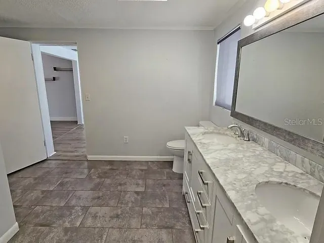 wooden floor fireplace and windows in an empty room