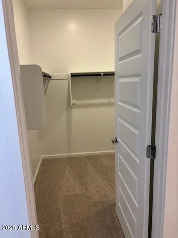 a kitchen with stainless steel appliances a sink a stove a microwave a refrigerator a sink and cabinets