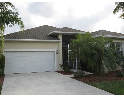 a front view of house with yard and trees