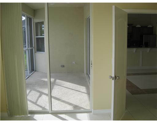 482 Northwest Emilia Way Stuart, FL 34994 - Photo 11 of 25 a bathroom with a glass shower door