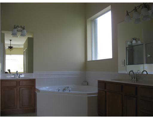 482 Northwest Emilia Way Stuart, FL 34994 - Photo 13 of 25 a bathroom with a sink and a mirror