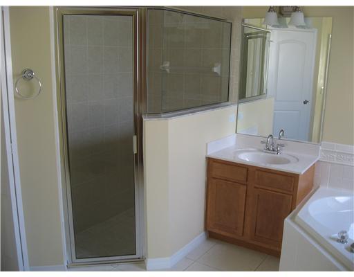 482 Northwest Emilia Way Stuart, FL 34994 - Photo 14 of 25 a bathroom with a sink and a mirror