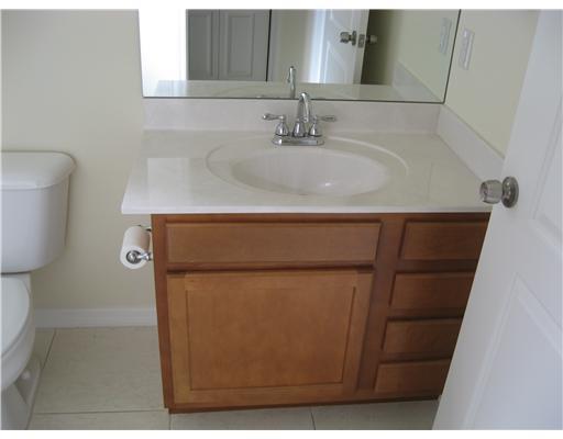 482 Northwest Emilia Way Stuart, FL 34994 - Photo 16 of 25 a bathroom with a sink and a mirror