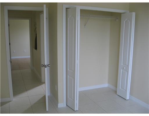 482 Northwest Emilia Way Stuart, FL 34994 - Photo 20 of 25 a bathroom with a glass shower door